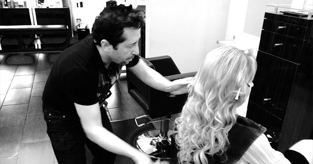 Umit Kuru styling a client in the salon